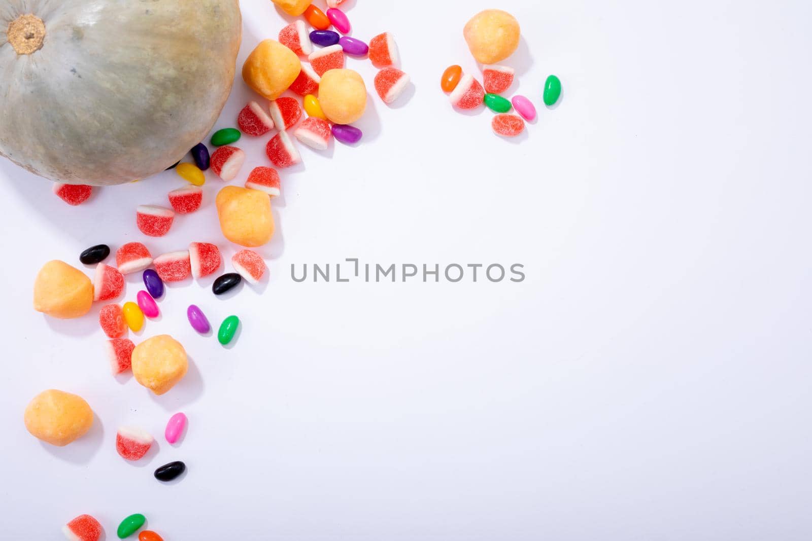 Composition of halloween pumpkin and trick or treat sweets with copy space on white background by Wavebreakmedia