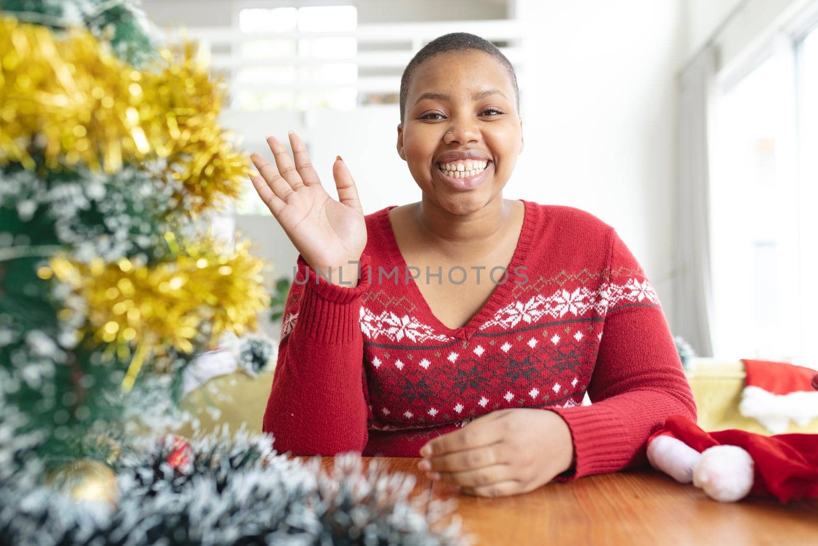 Happy african american plus size woman i making christmas video call on laptop. christmas, festivity and communication technology.