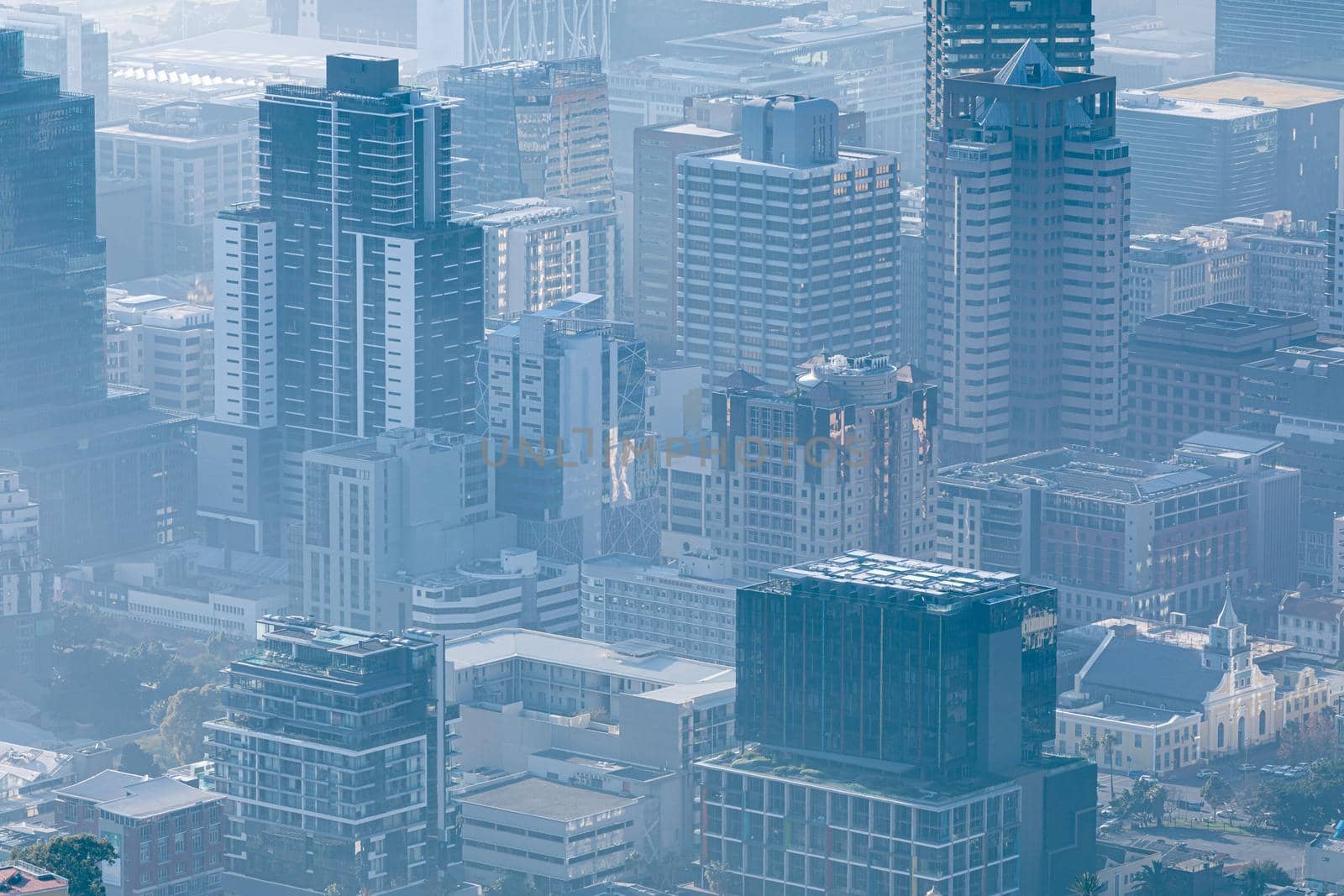 General view of cityscape with multiple modern buildings and skyscrapers in the foggy morning by Wavebreakmedia