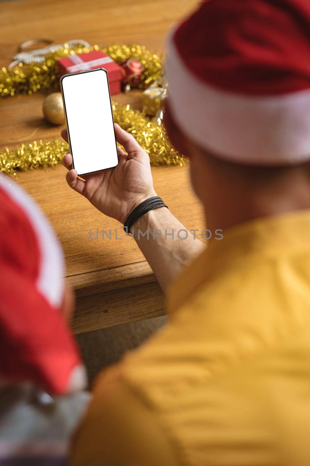 Rear view of father and son having a video call on smartphone with copy space during christmas by Wavebreakmedia