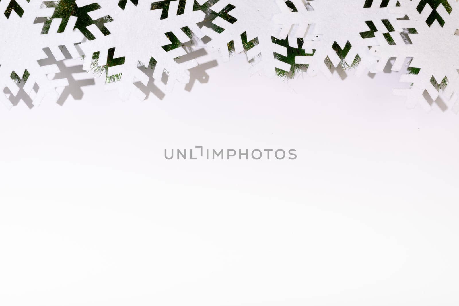 Composition of fir tree branches with snowflakes and copy space on white background. christmas, tradition and celebration concept.