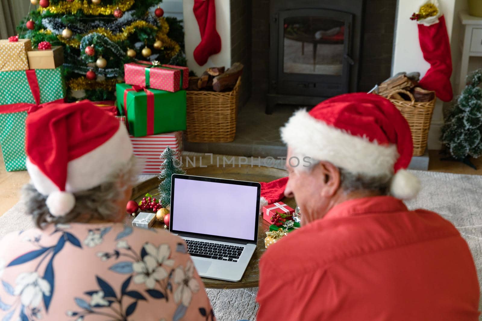 Caucasian senior couple wearing santa hats using laptop with copy space at christmas time by Wavebreakmedia