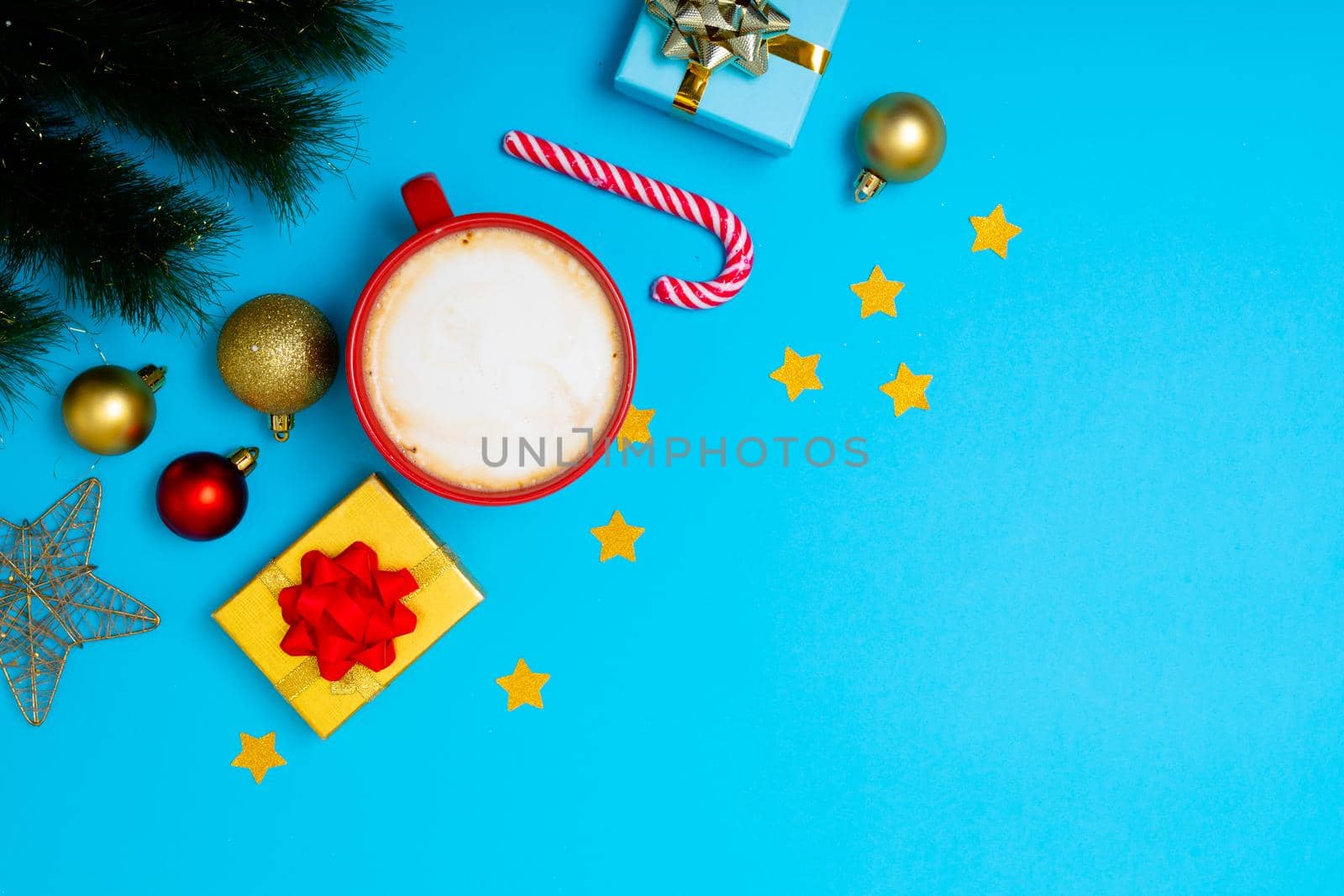Composition of christmas decorations with baubles, presents, mug and copy space on blue background. christmas, tradition and celebration concept.