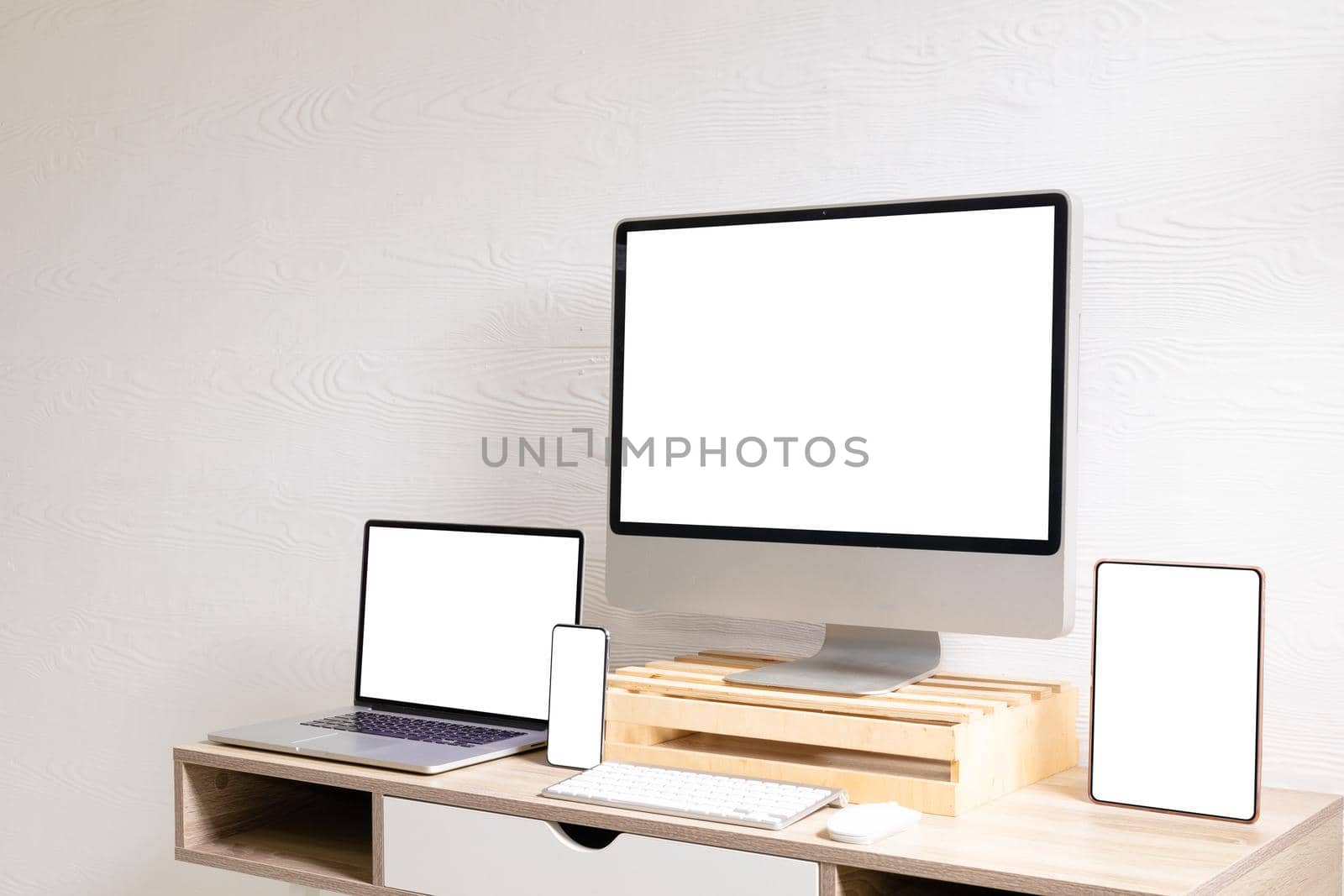 Composition of desktop computer, laptop, tablet and smartphone with copy space on white background by Wavebreakmedia