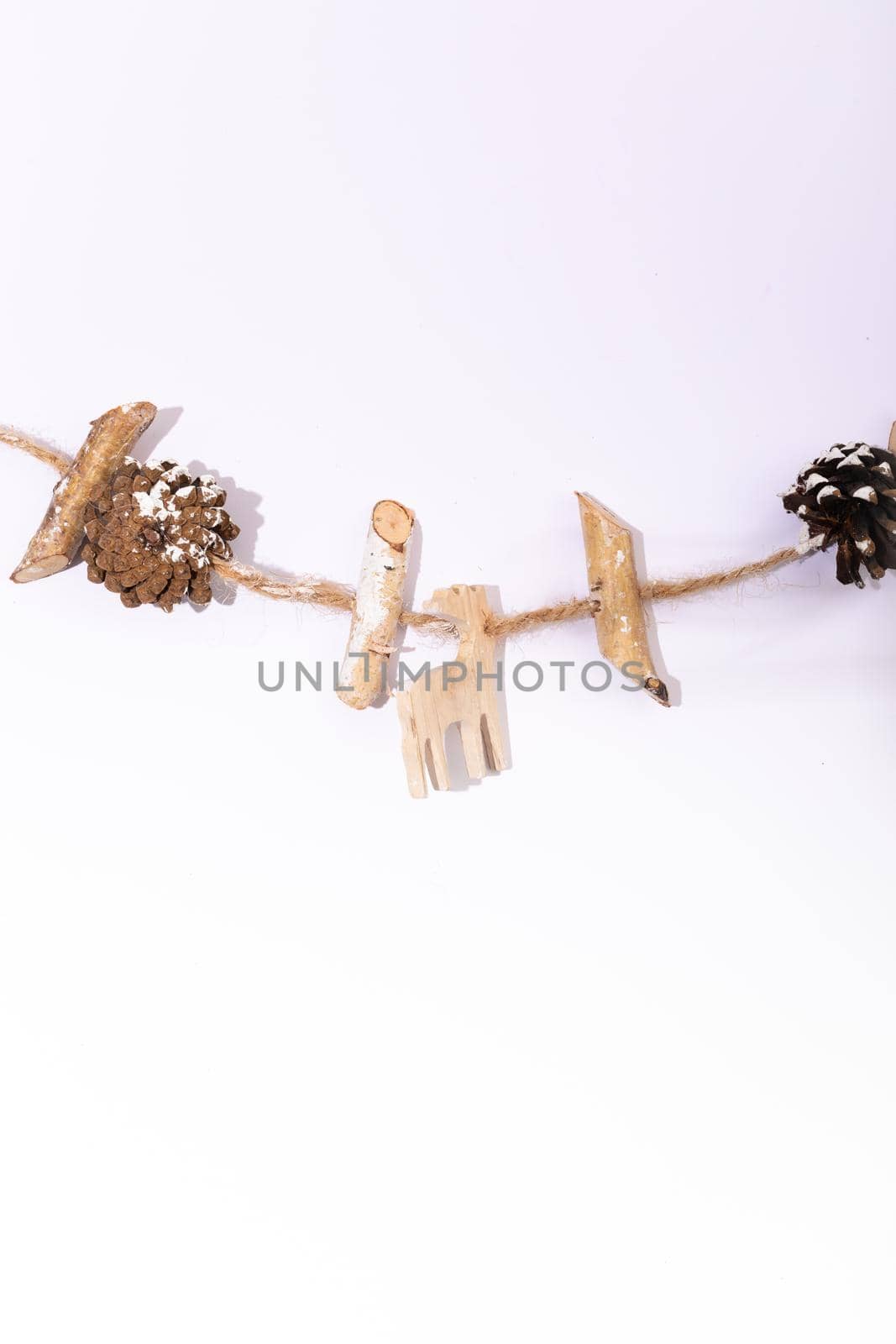 Composition of christmas decorations with pine cones and copy space on white background. christmas, tradition and celebration concept.