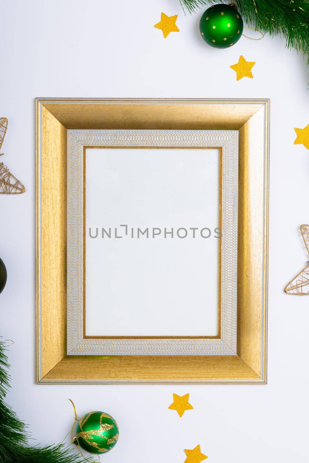 Composition of frame with copy space and fir tree branches with baubles on white background by Wavebreakmedia