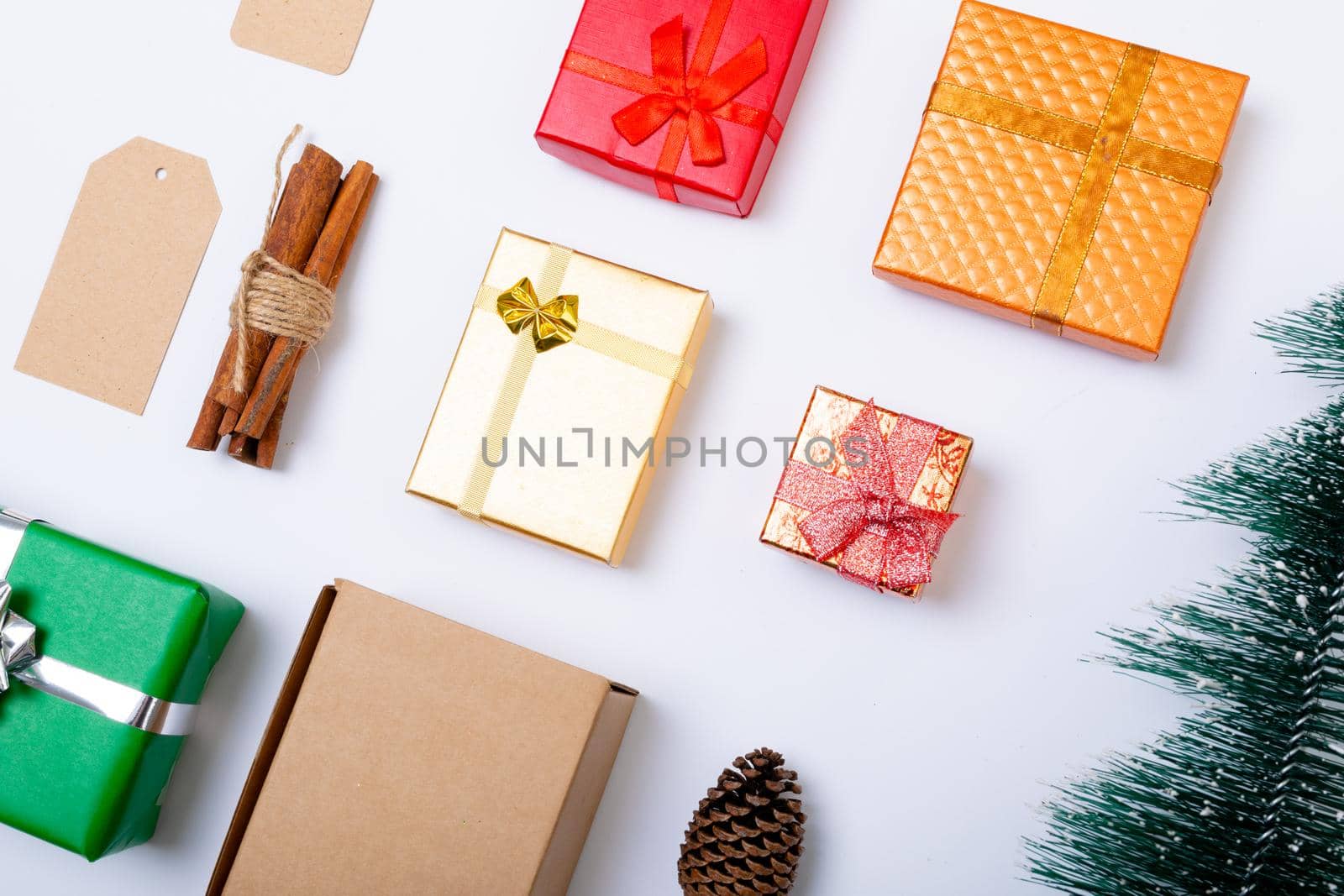 Composition of christmas decorations with presents and christmas tree on white background. christmas, tradition and celebration concept.