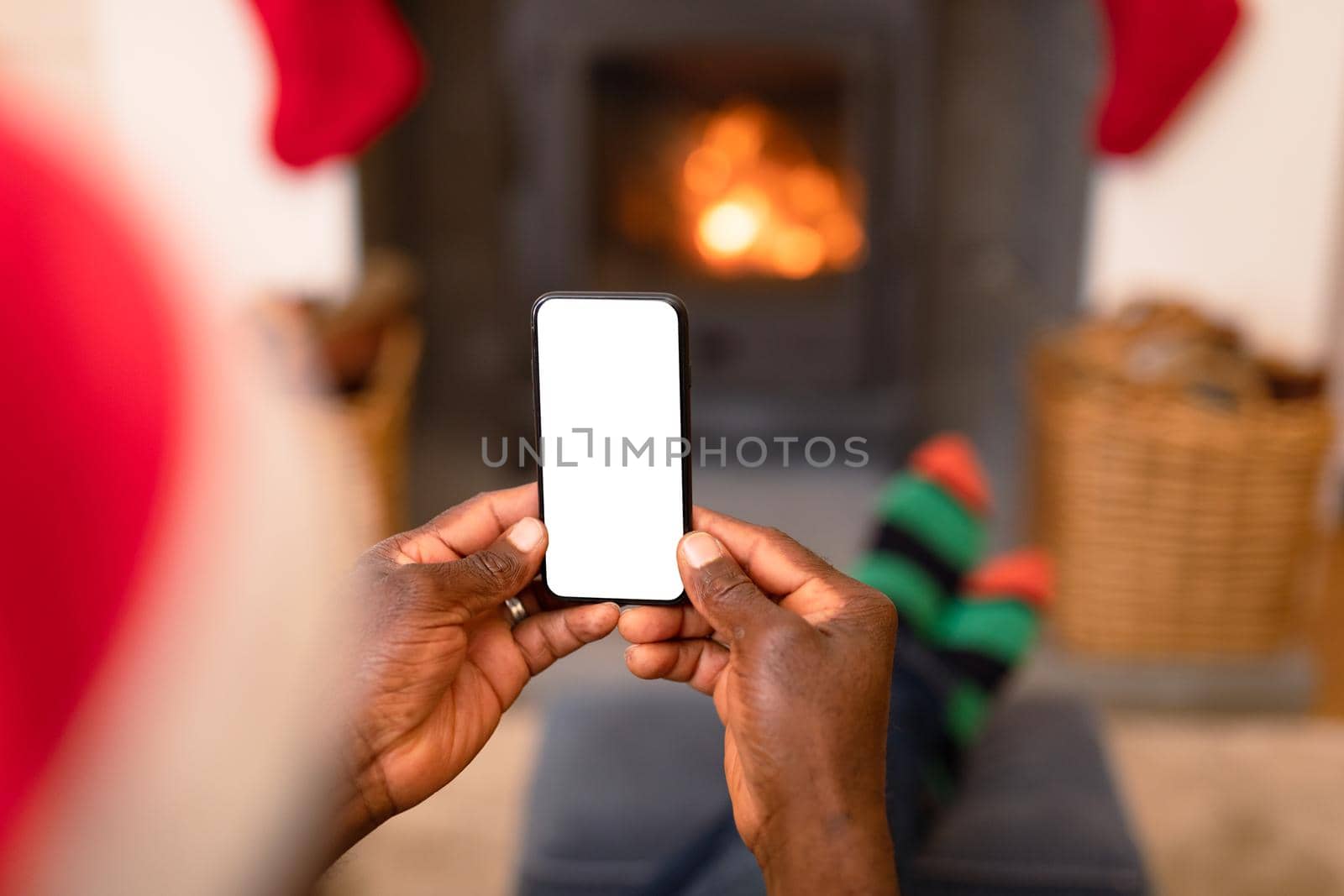 Back view of african american senior man using smartphone with copy space at christmas time by Wavebreakmedia