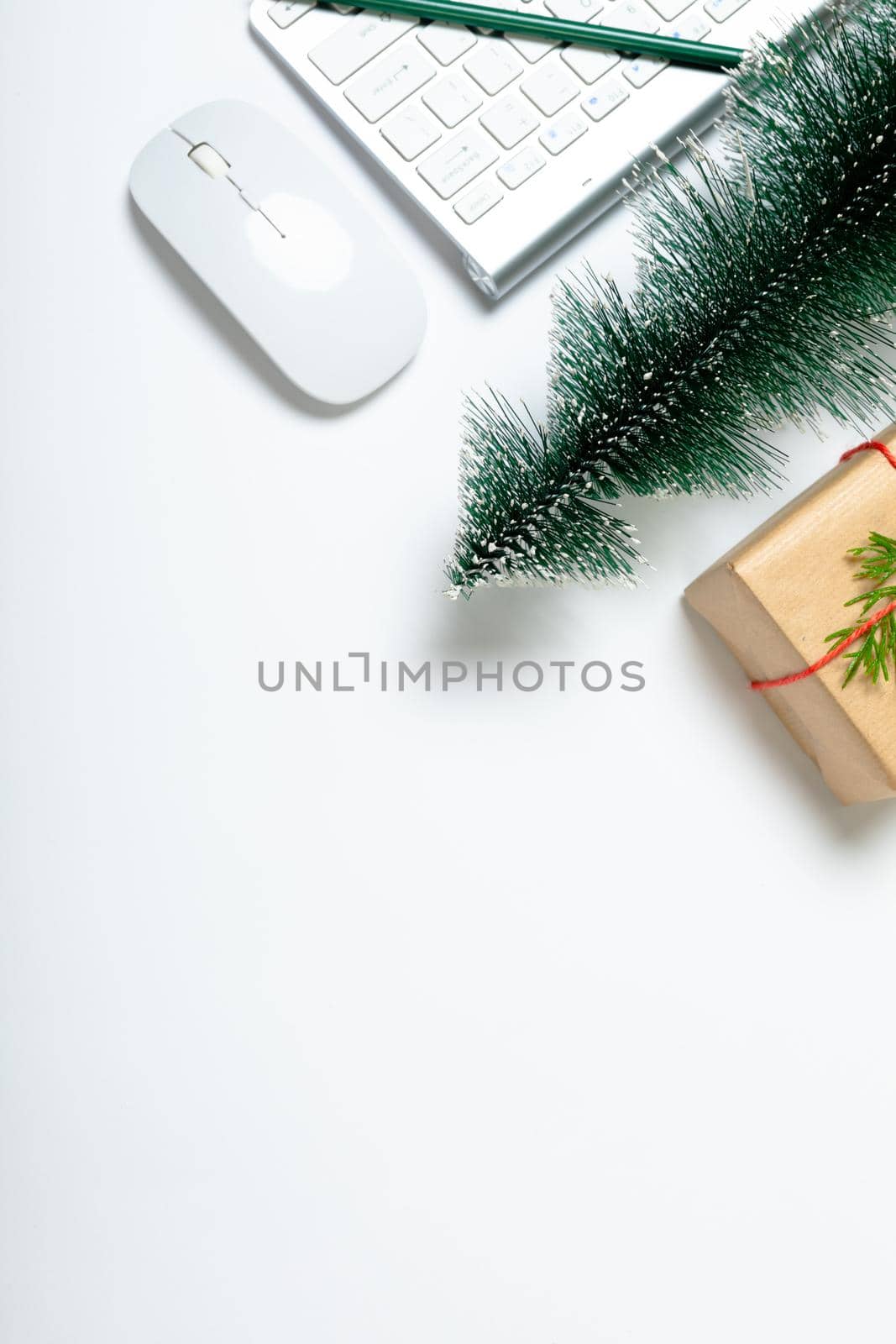 Composition of laptop with christmas tree, present and copy space on white background. christmas, communication, tradition and celebration concept.