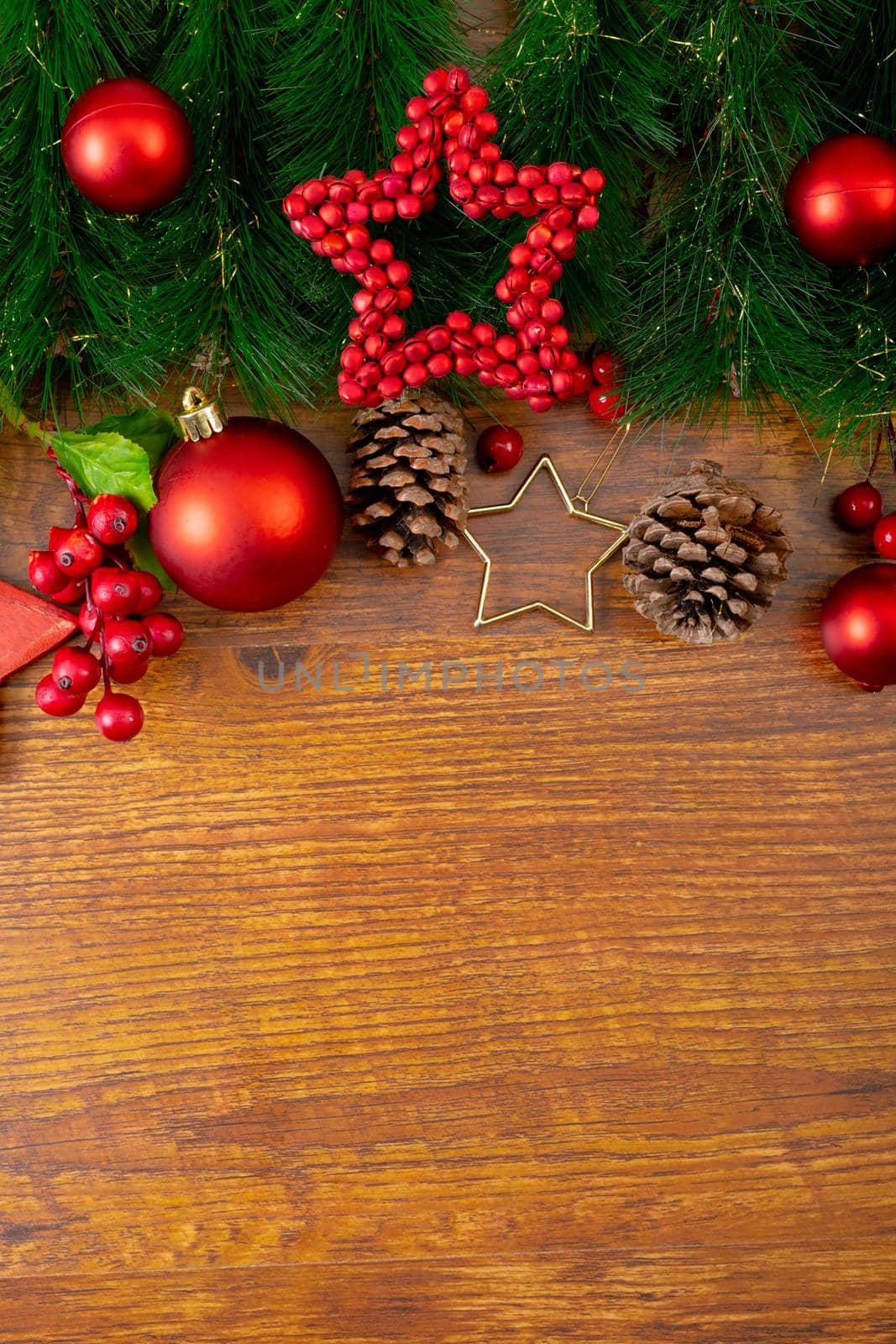 Composition of christmas decorations with fir tree, baubles and copy space on wooden background by Wavebreakmedia