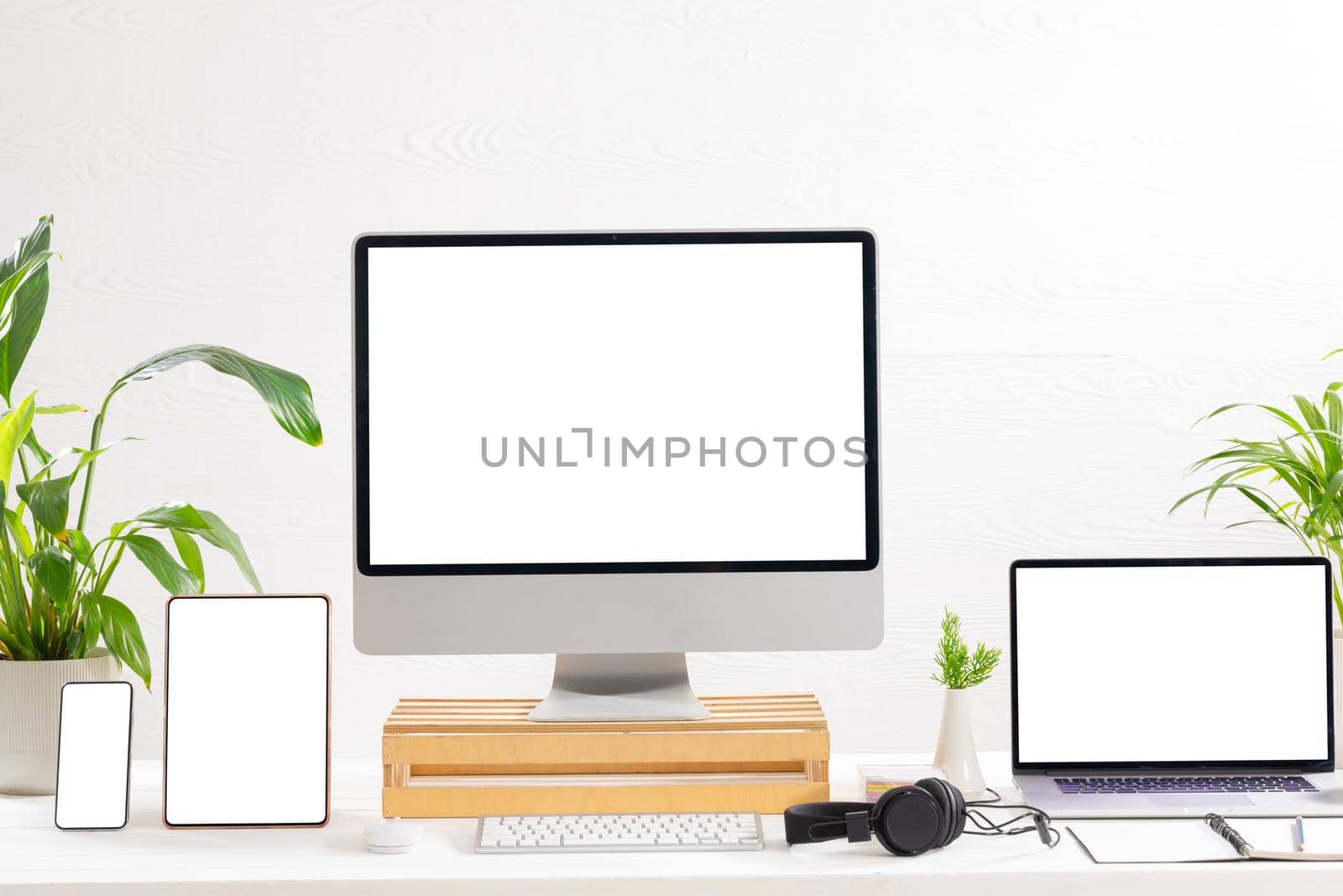 Composition of desktop computer, laptop, tablet and smartphone with copy space on white background. modern office communication and technology concept.