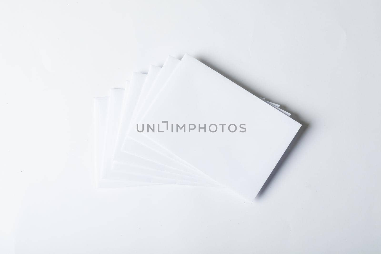 Composition of blank white cards with copy space on white background by Wavebreakmedia