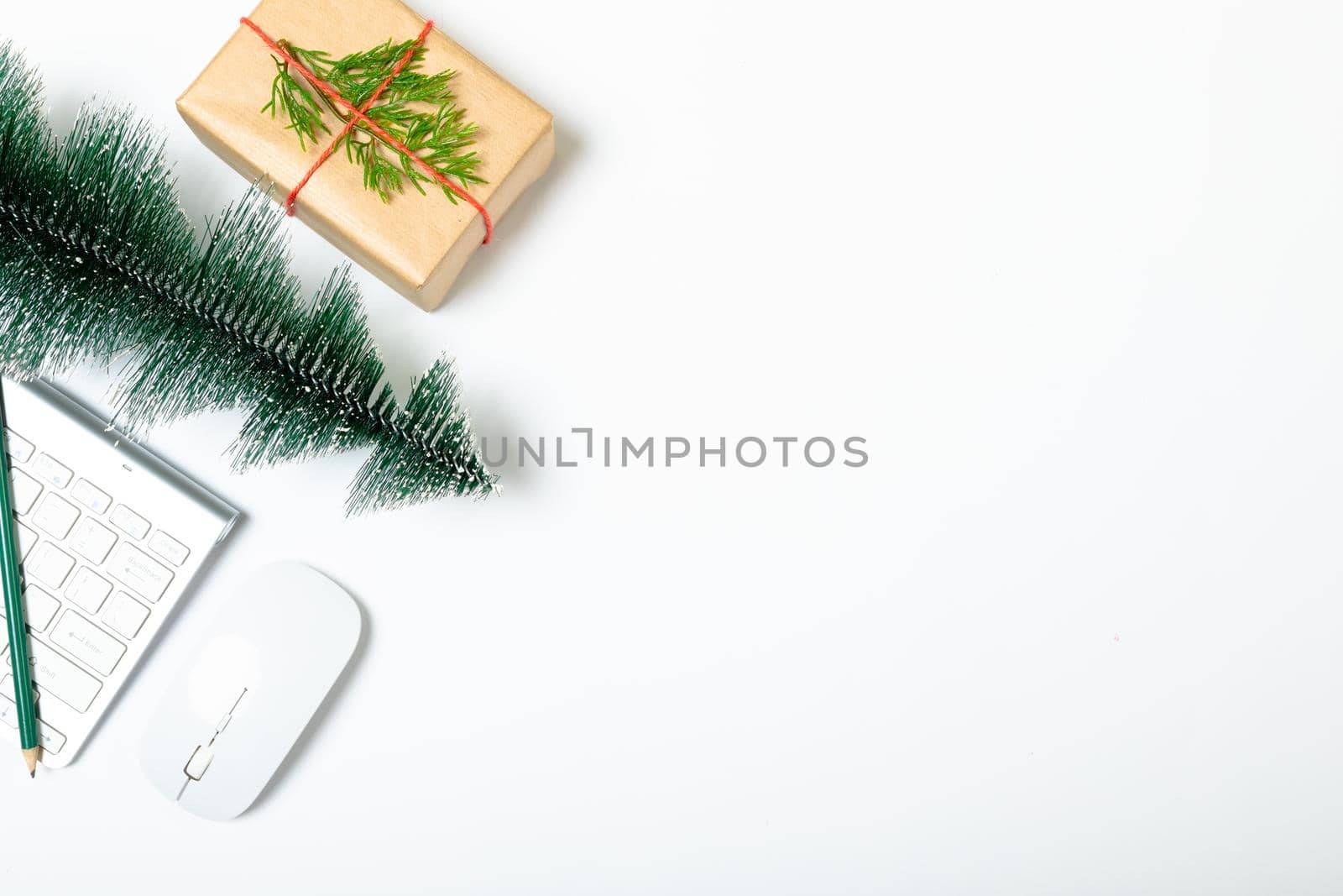 Composition of laptop with christmas tree, present and copy space on white background by Wavebreakmedia