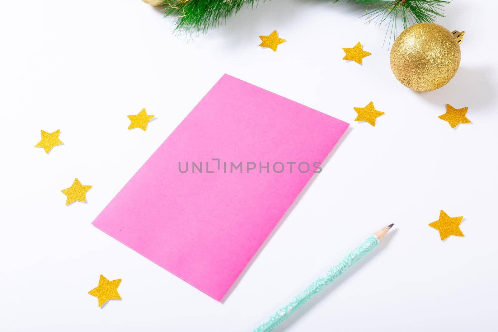 Composition of pink card with copy space, stars, pencil and bauble on white background by Wavebreakmedia