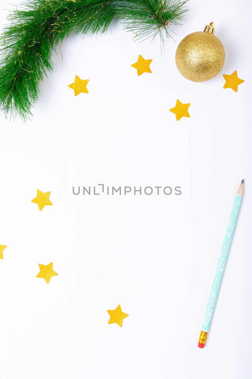 Composition of christmas decorations with bauble, stars, pencil and copy space on white background by Wavebreakmedia