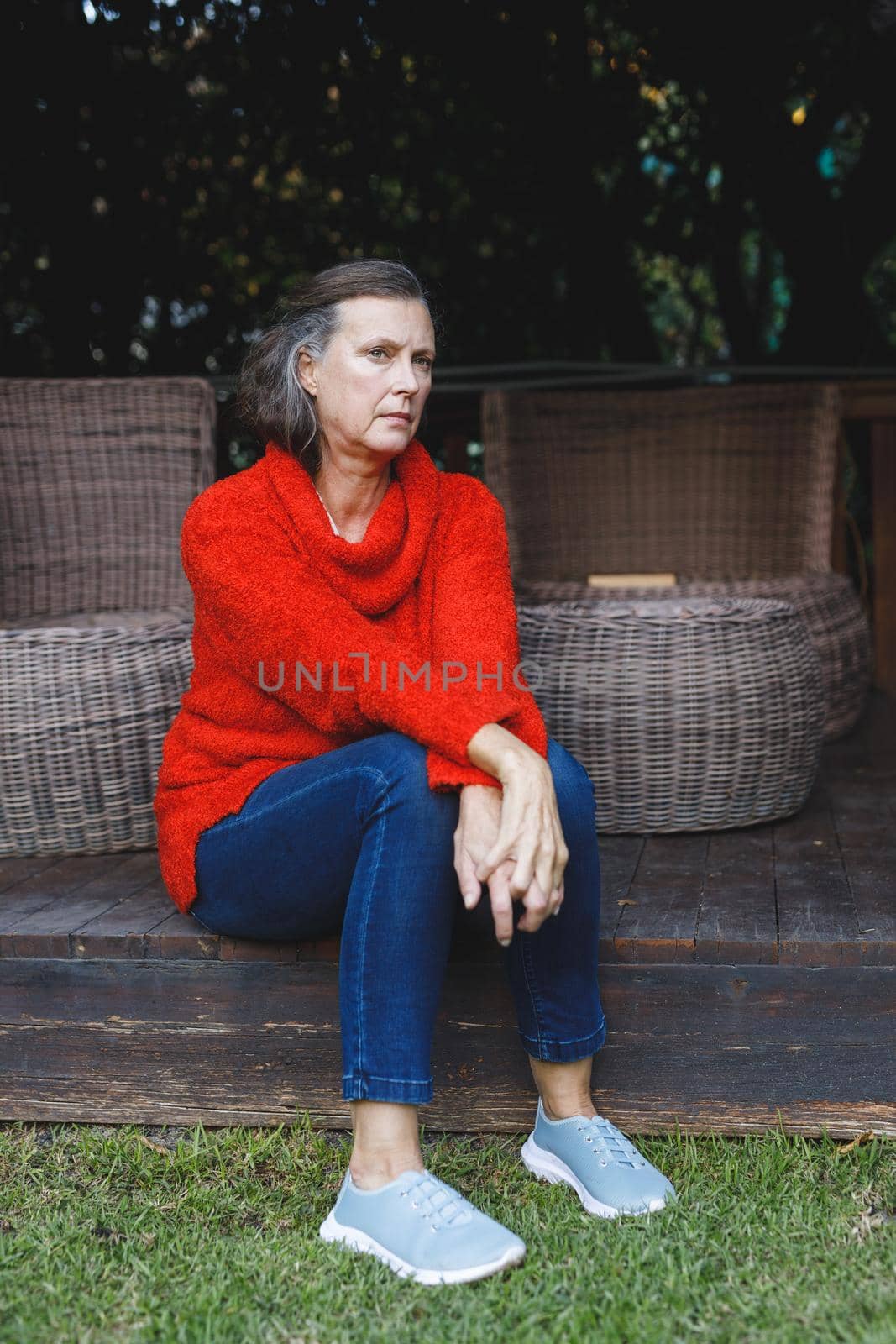 Thoughtful senior caucasian woman sitting and looking away in garden by Wavebreakmedia