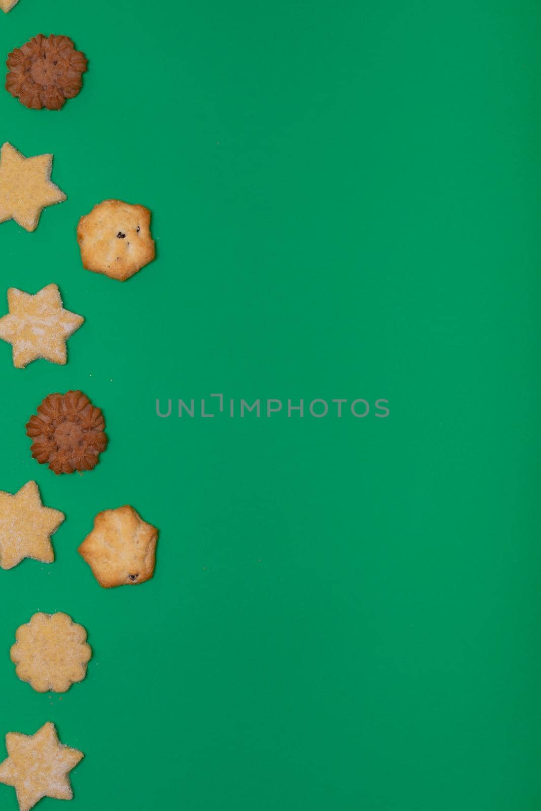 Composition of christmas cookies and copy space on green background by Wavebreakmedia
