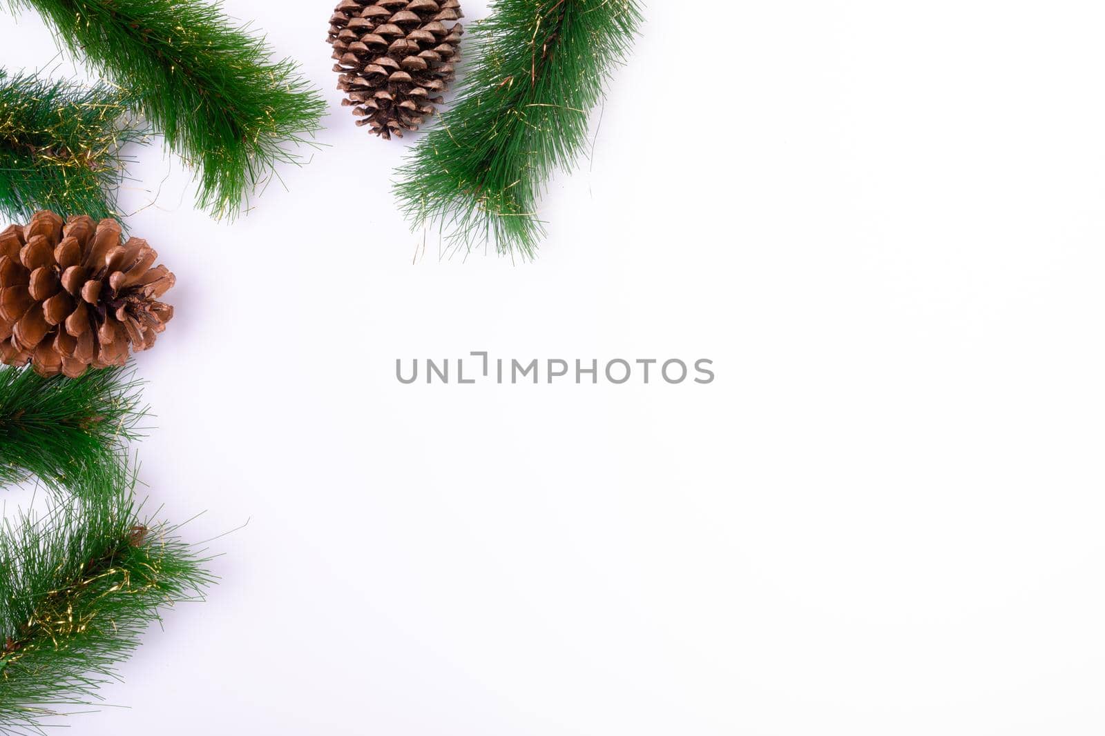 Composition of fir tree branches with pine cones and copy space on white background. christmas, tradition and celebration concept.