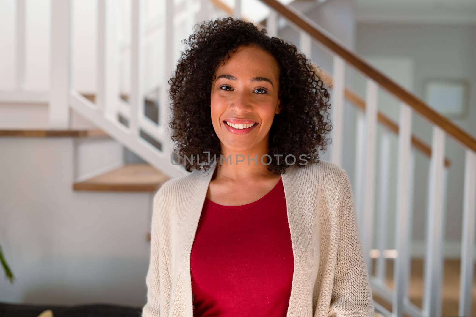 Portrait of african american woman looking at camera and smiling. lifestyle, leisure and spending time at home.