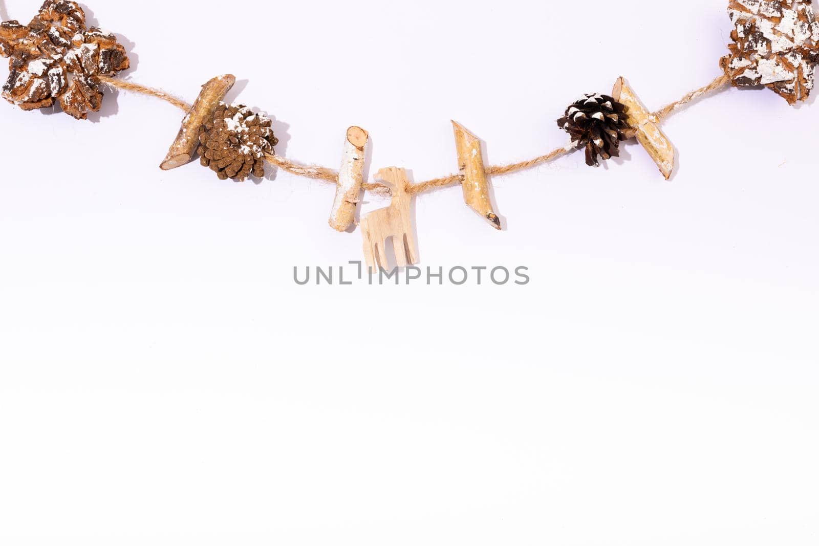 Composition of christmas decorations with pine cones and copy space on white background. christmas, tradition and celebration concept.