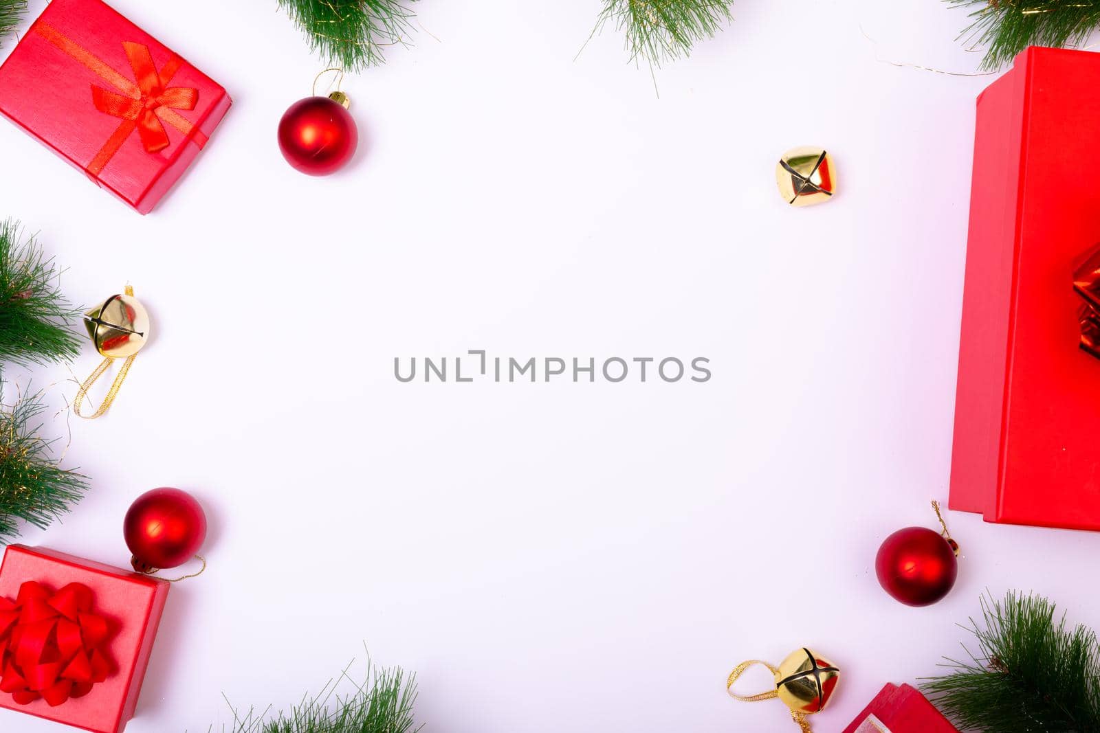 Composition of christmas decorations with baubles, presents and copy space on white background. christmas, tradition and celebration concept.
