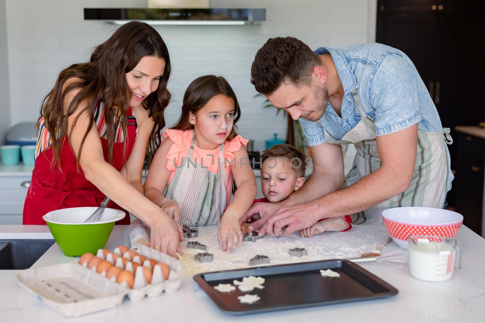 Happy caucasian family baking together, making cookies in kitchen by Wavebreakmedia