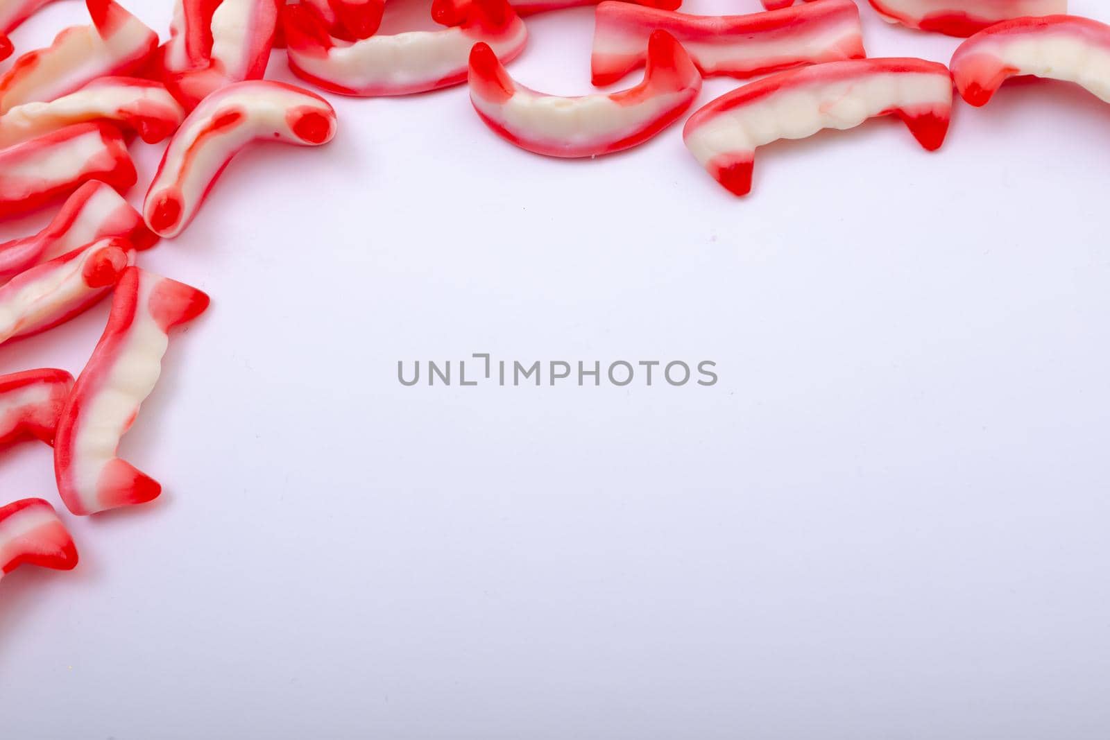Composition of halloween jelly teeth trick or treat sweets with copy space on white background by Wavebreakmedia