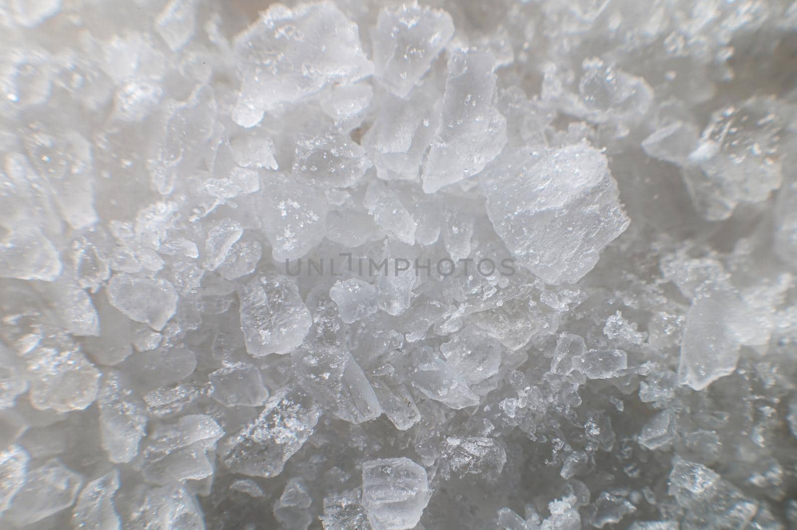 Macro view of crystals of table salt. Taste useful additive saline solutions background in shallow depth of field. Close-up.