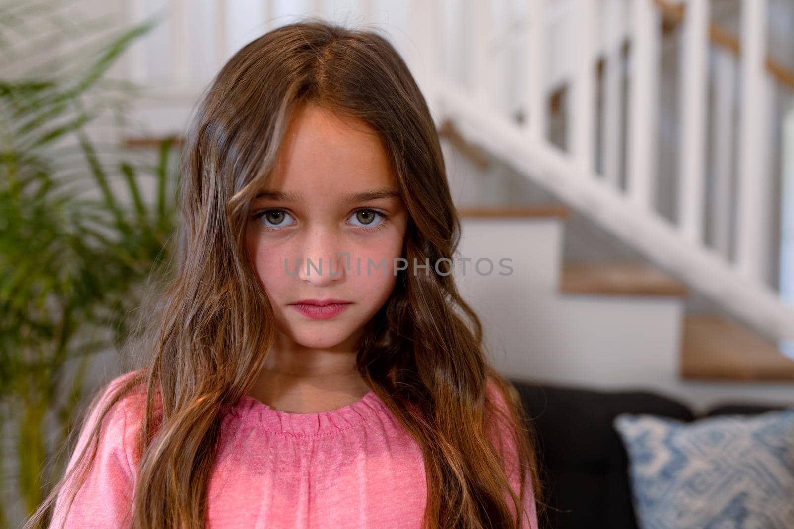 Sad caucasian girl looking at camera at home by Wavebreakmedia