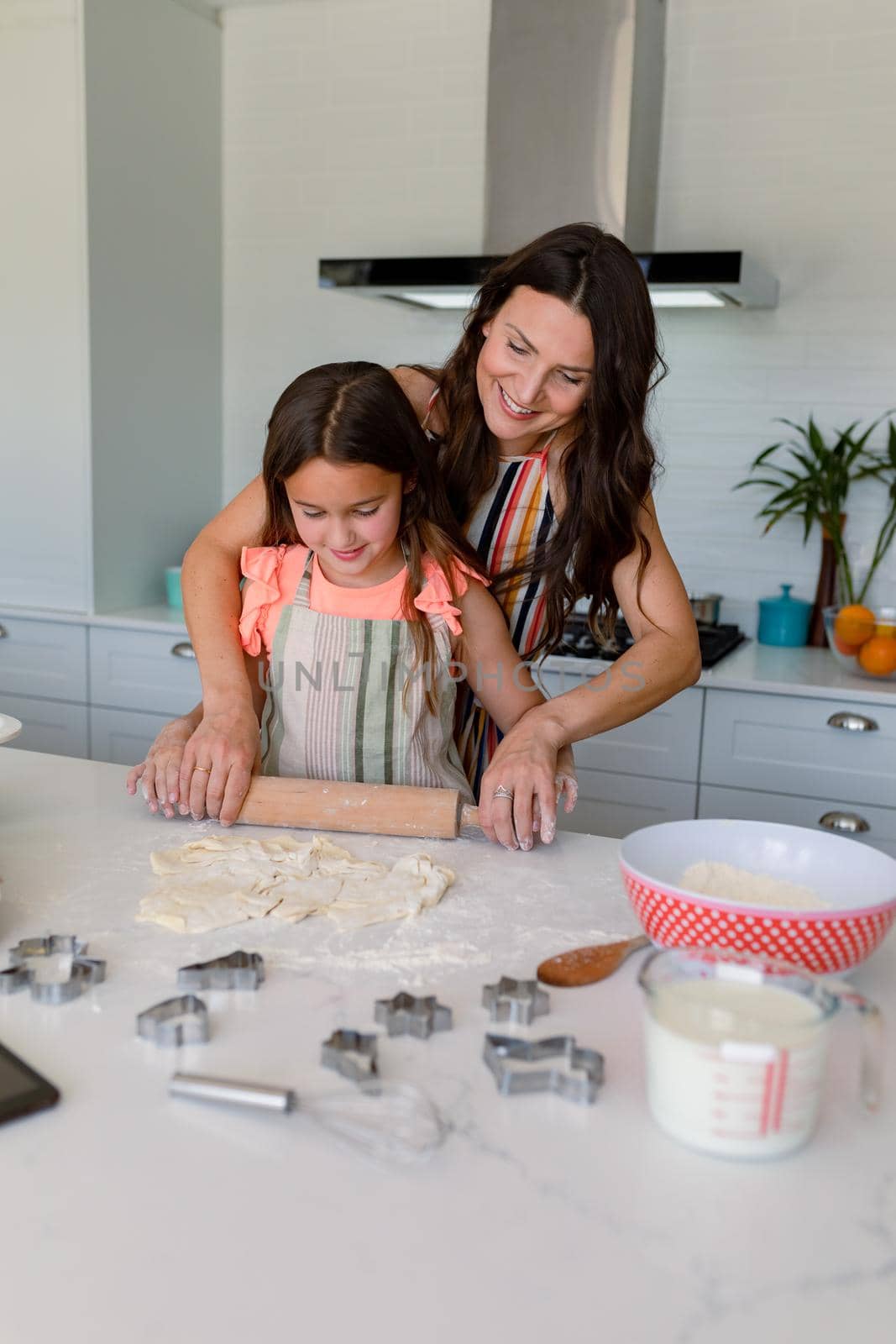 Happy caucasian mother and daughter baking together, making cookies in kitchen by Wavebreakmedia