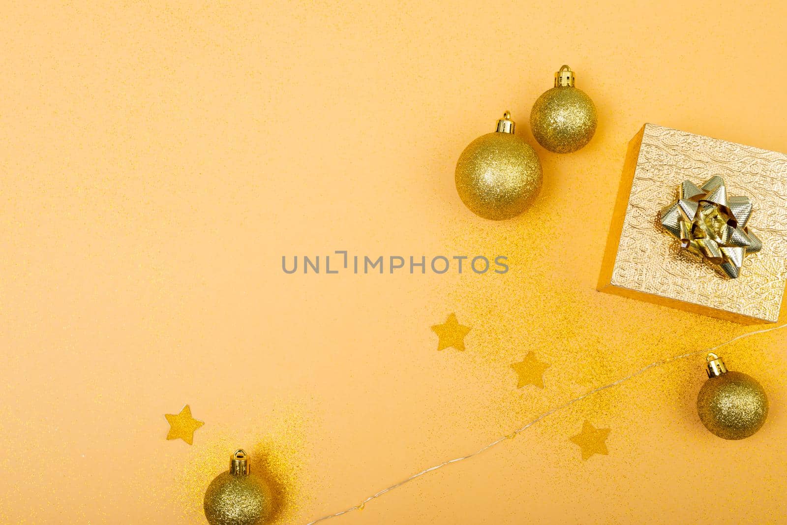 Composition of christmas decorations with presents and copy space on yellow background by Wavebreakmedia