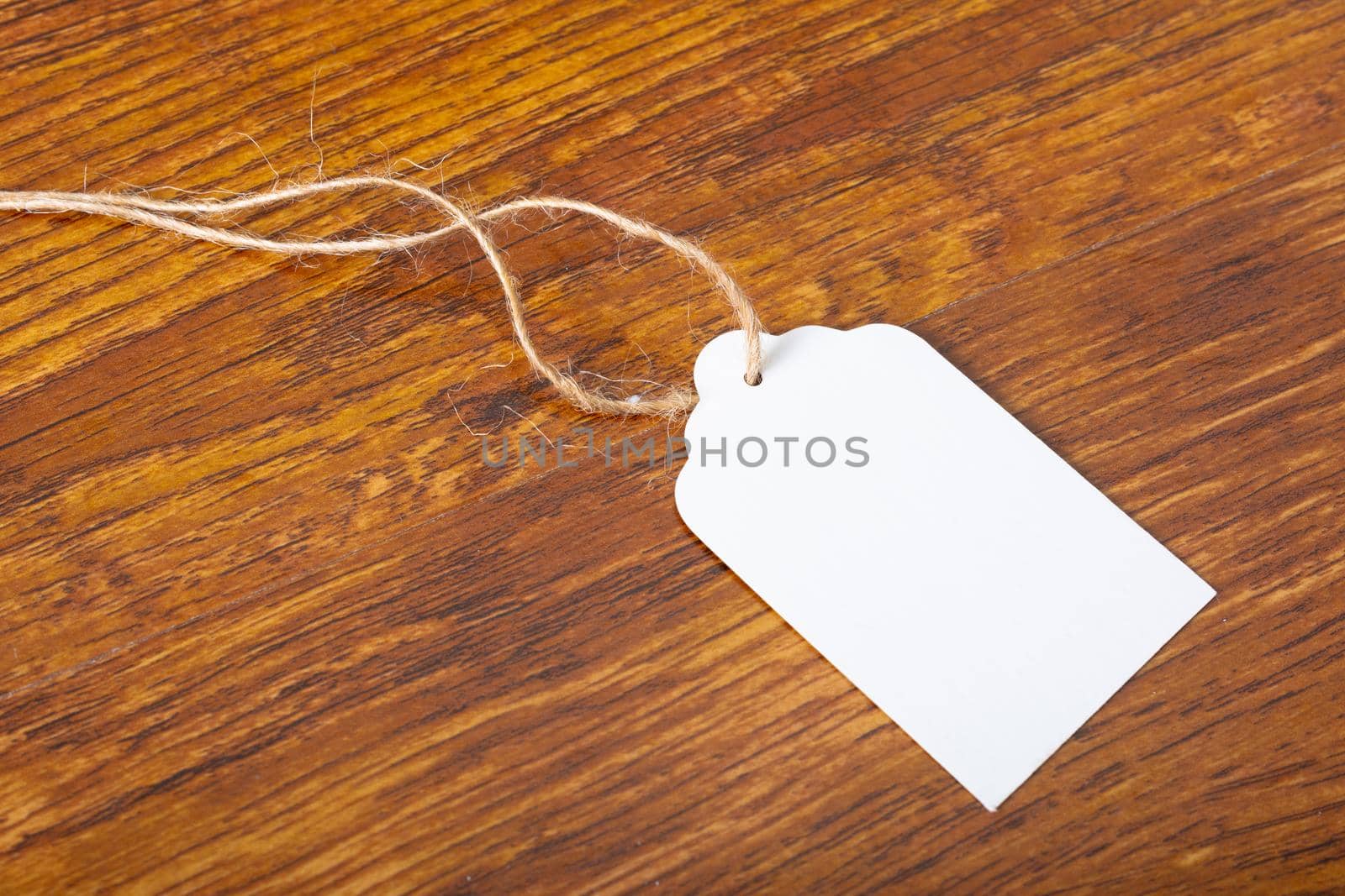 Composition of white label card with copy space on wooden background. christmas, tradition and celebration concept.