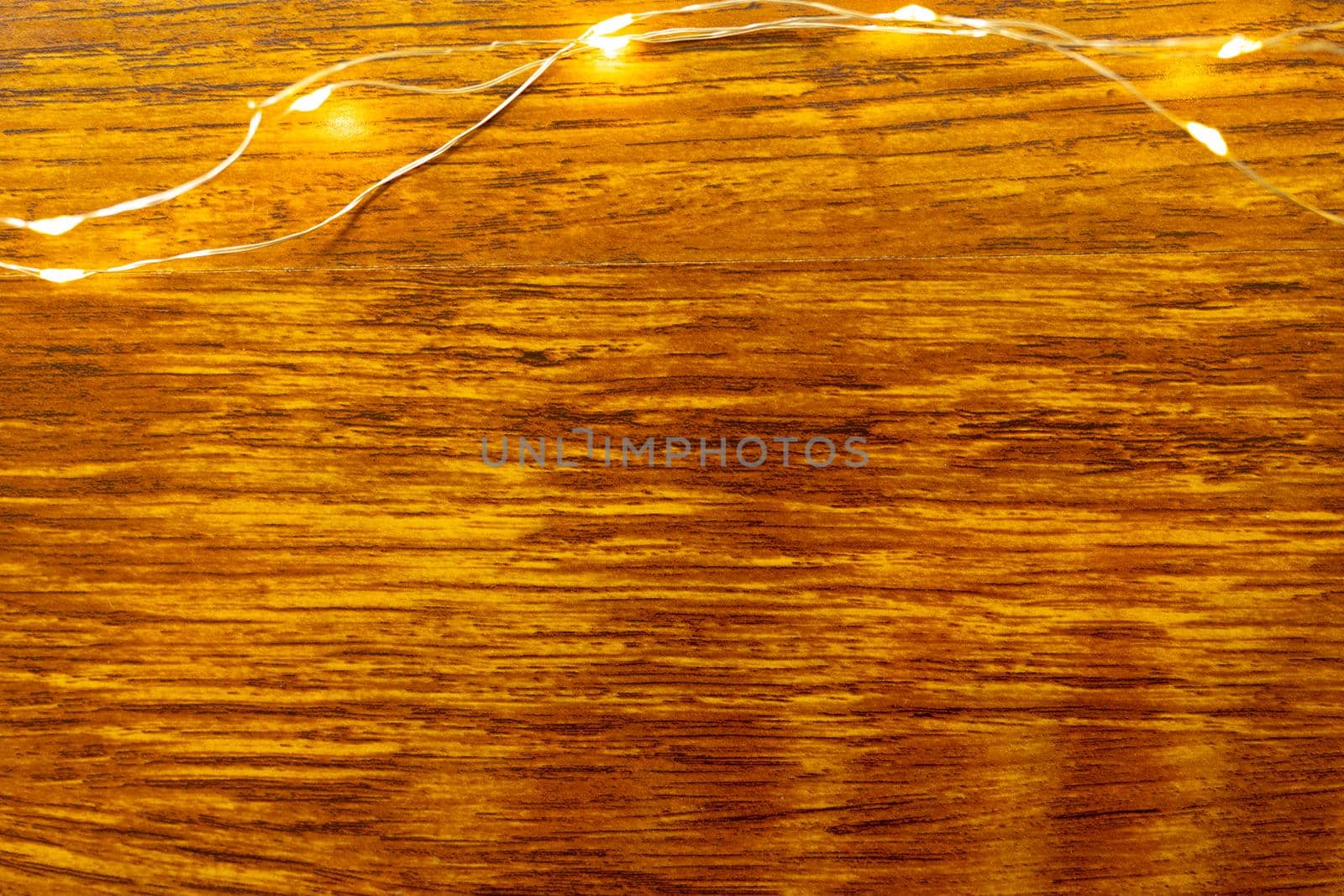 Composition of fairy lights and copy space on wooden background. christmas, tradition and celebration concept.