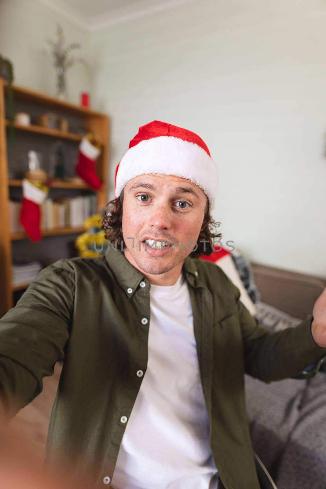 Portrait of caucasian disabled man in santa hat sitting on a wheelchair at home during christmas by Wavebreakmedia