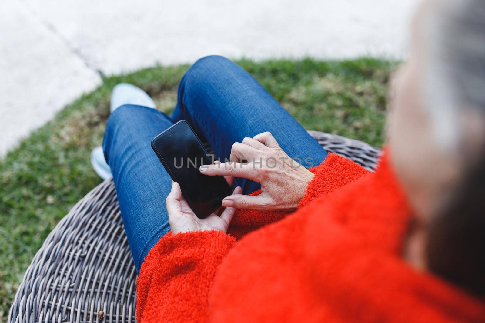 Midsection of senior caucasian woman using smartphone in garden by Wavebreakmedia