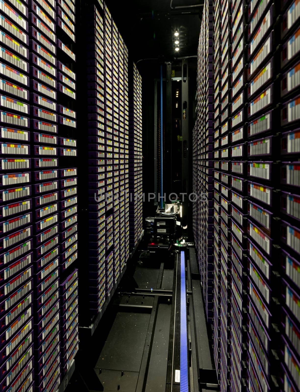 Data center with multiple rows of fully operational server racks by Wavebreakmedia