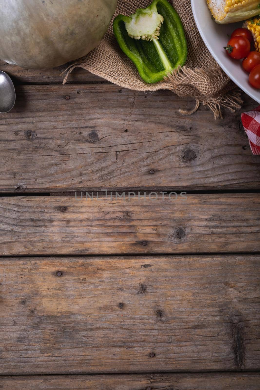Close up of multiple food ingredients and cutlery with copy space on wooden surface by Wavebreakmedia
