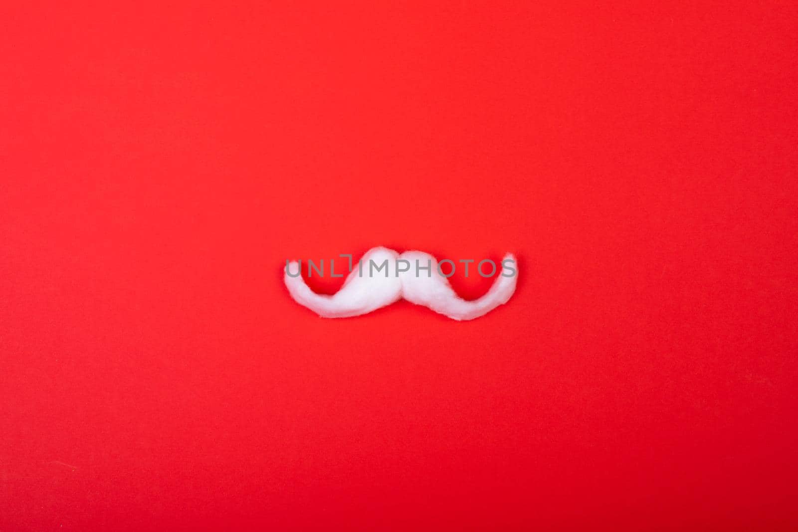 Composition of white santa claus moustache with copy space on red background by Wavebreakmedia