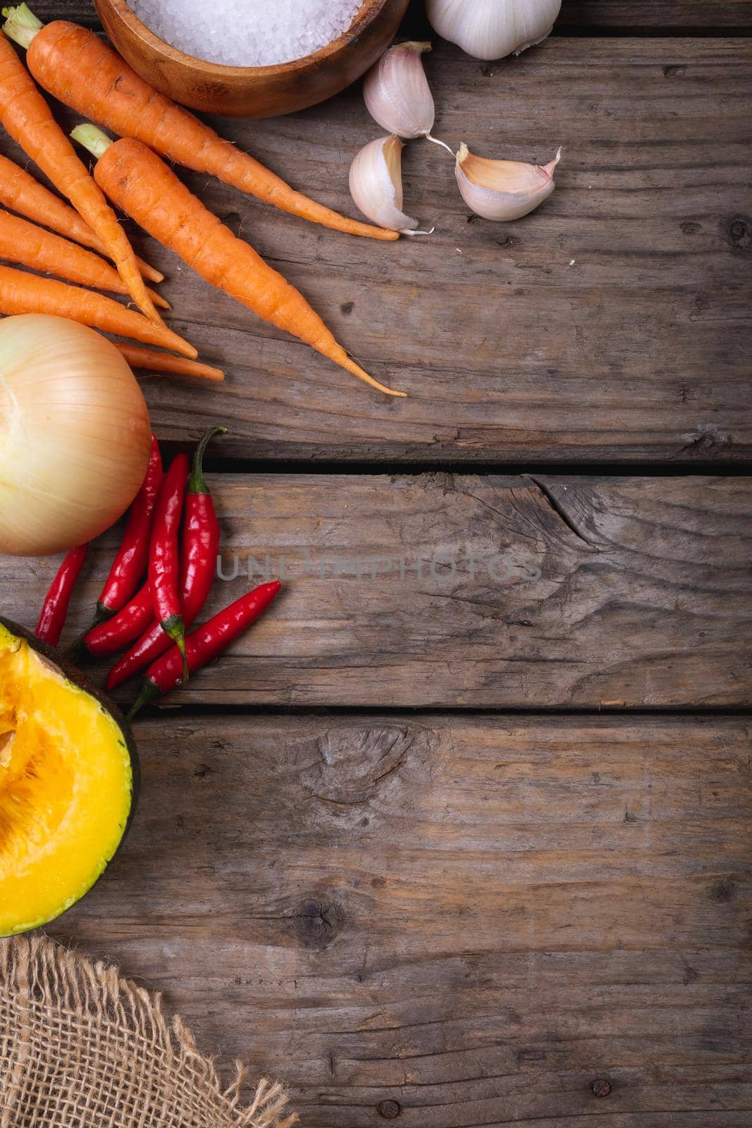 Close up of multiple food ingredients and cutlery with copy space on wooden surface by Wavebreakmedia