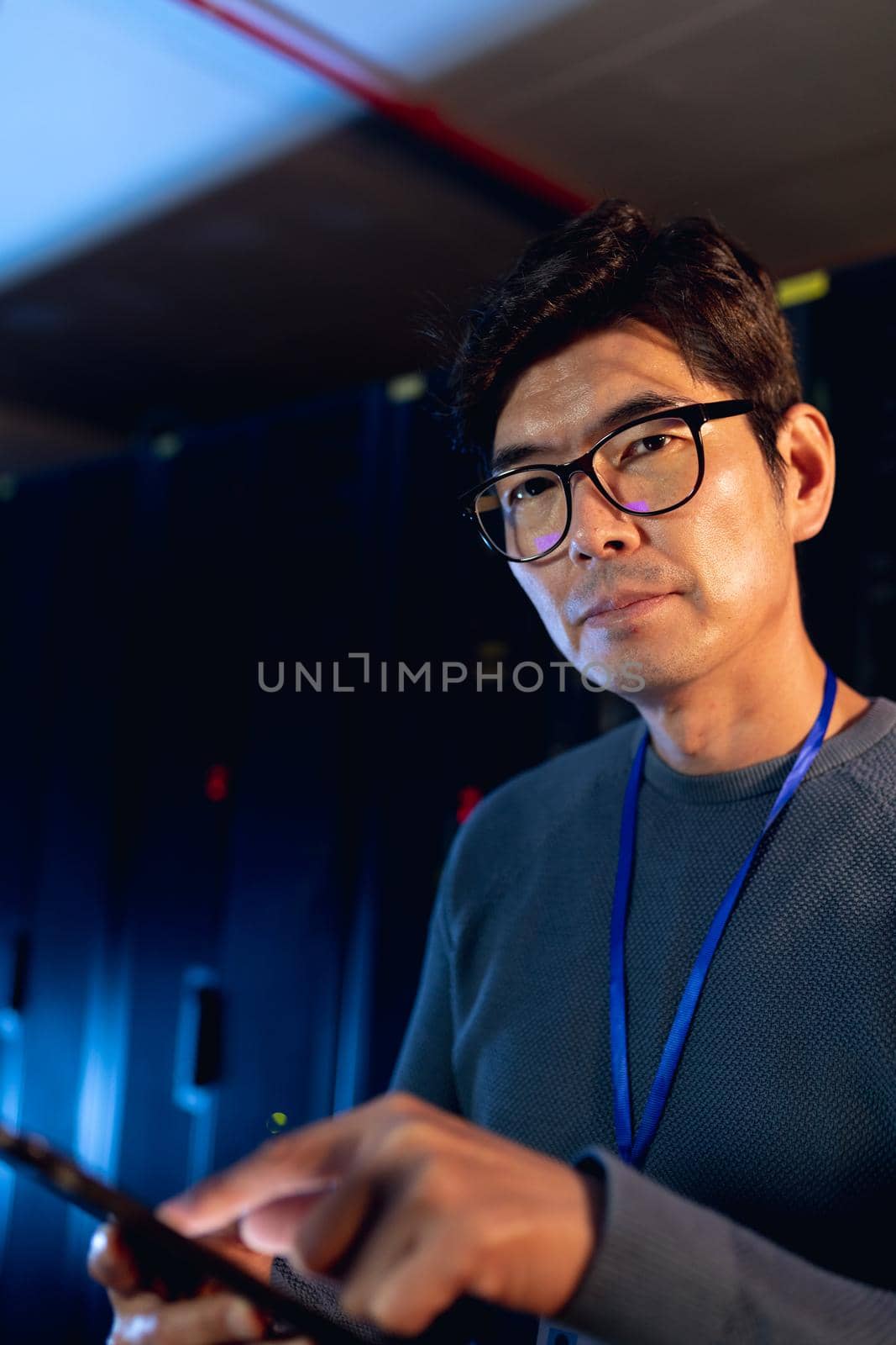 Portrait of asian male engineer using digital tablet in computer server room by Wavebreakmedia