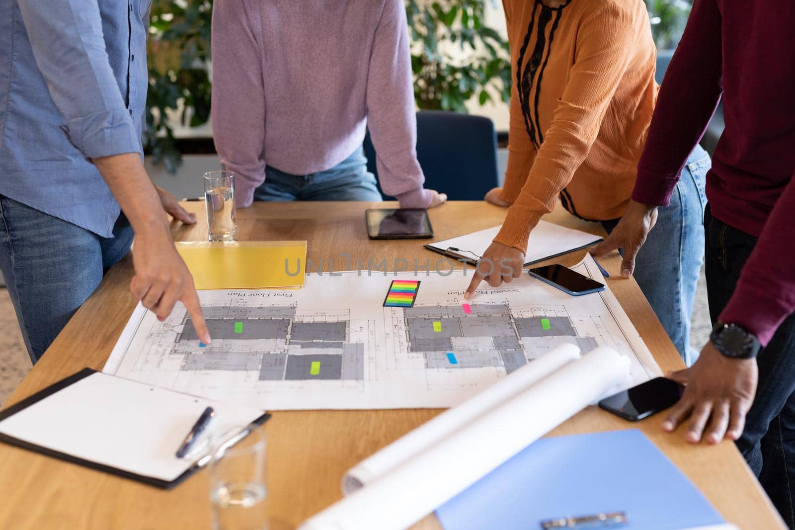 Diverse group of business people working in creative office. group of people in a meeting discussing work. business people and work colleagues at a busy creative office.