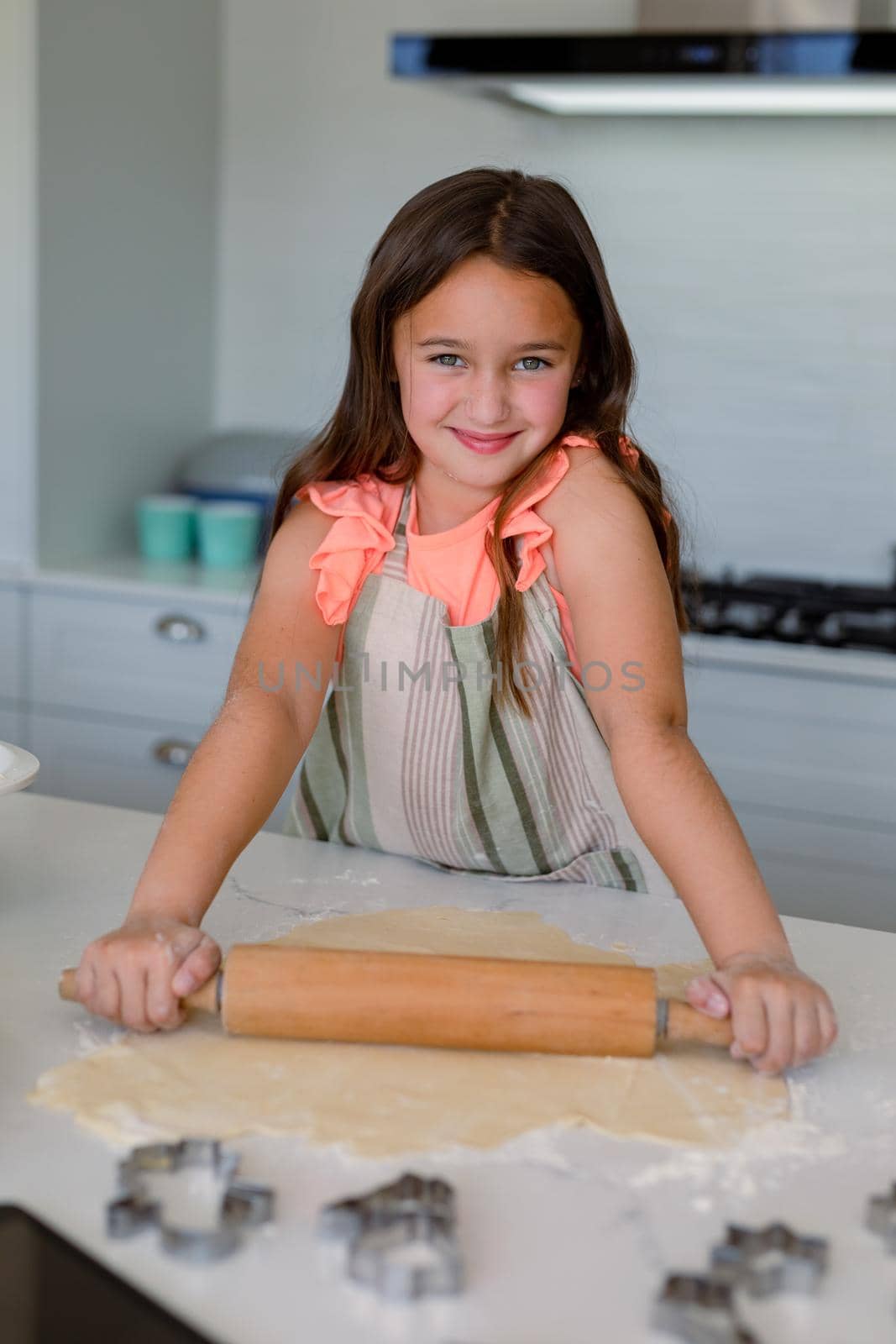 Portrait of happy caucasian girl baking, making cookie in kitchen by Wavebreakmedia