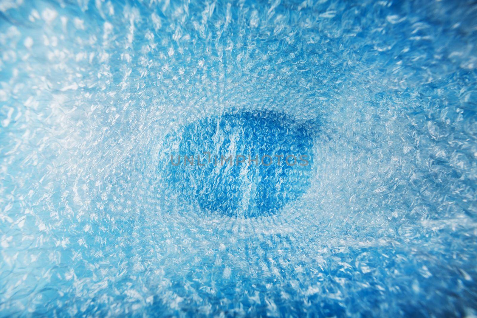 Full screen view of the inside of the package from the packaging air-bubble film on a blue background