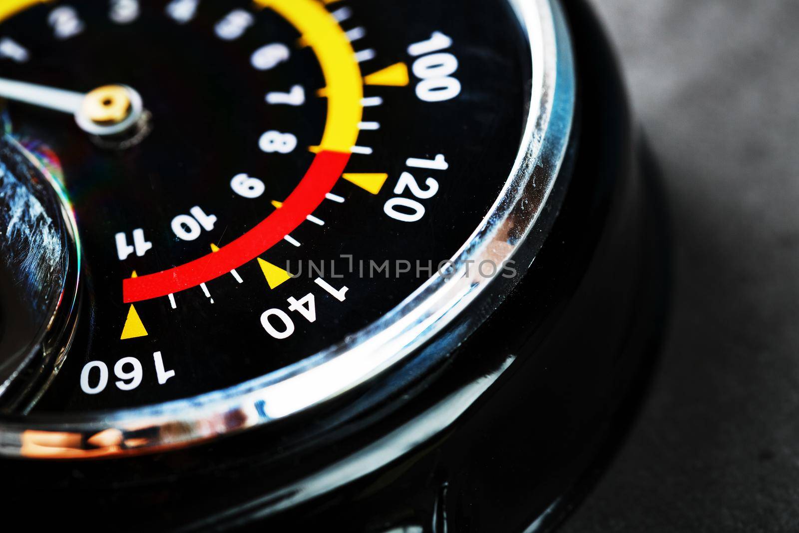 Hand air pump manometer for pressure control on a dark background close-up