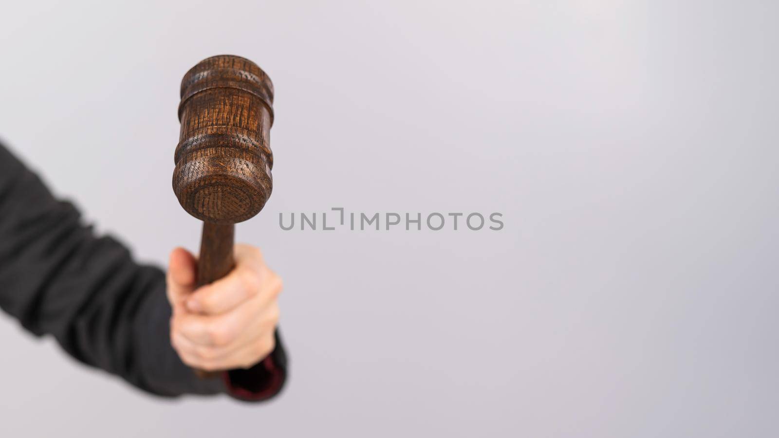 Woman holding judge's gavel on white background