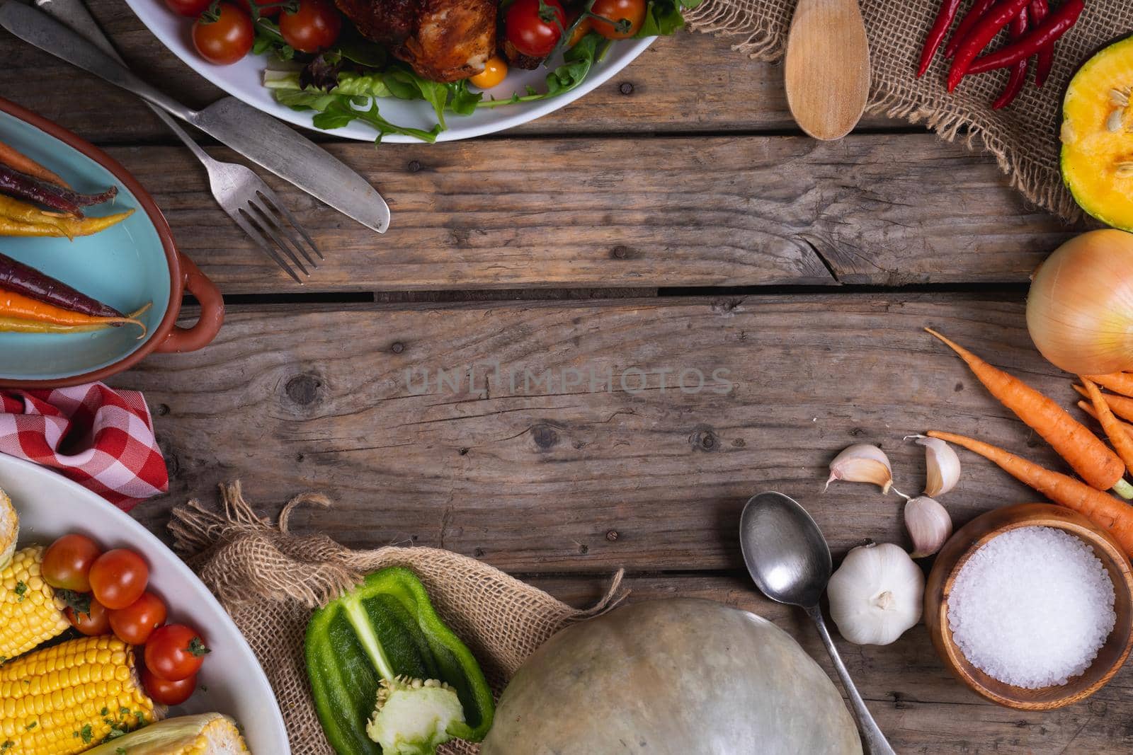 Close up of multiple food ingredients and cutlery with copy space on wooden surface. food and restaurant concept