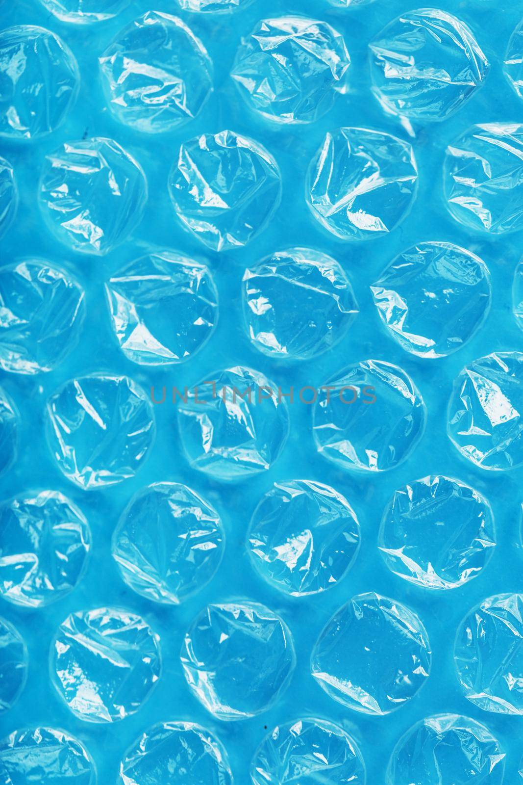The texture of the packaging air-bubble film on a blue background in full screen by AlexGrec