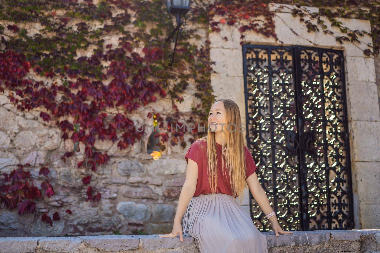 Woman tourist on background of beautiful view of the island of St. Stephen, Sveti Stefan on the Budva Riviera, Budva, Montenegro. Travel to Montenegro concept by galitskaya