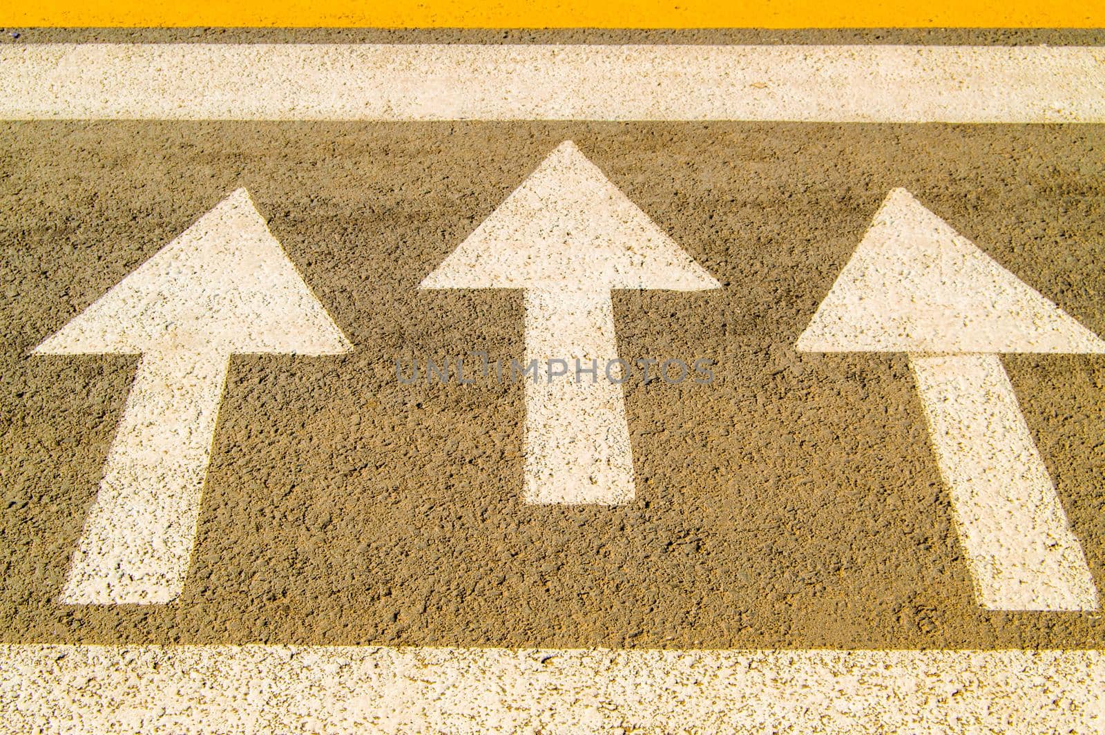 Asphalt road with arrow sign shows the direction of movement by claire_lucia