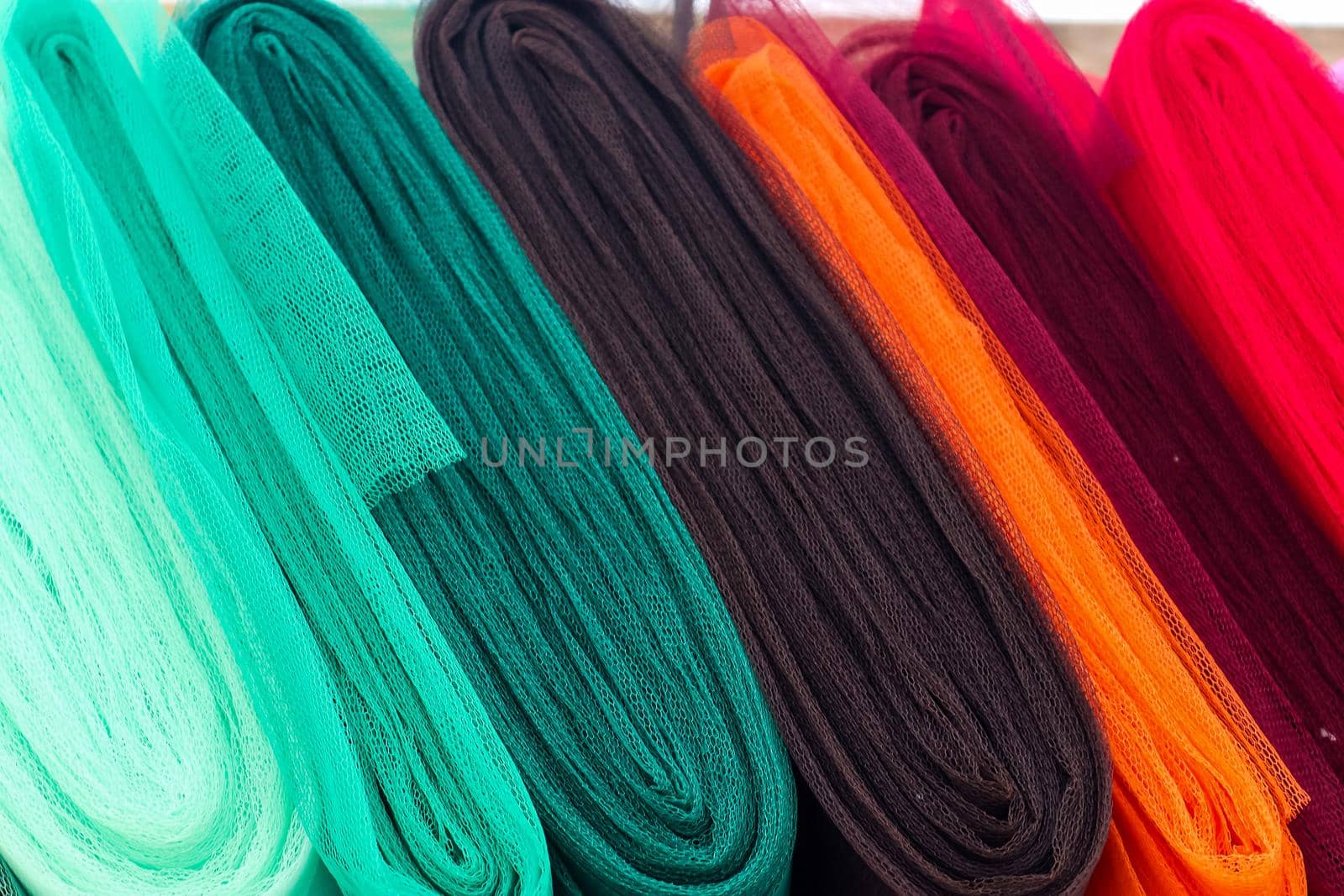 Detailed close up view on samples of cloth and fabrics in different colors found at a fabrics market by MP_foto71